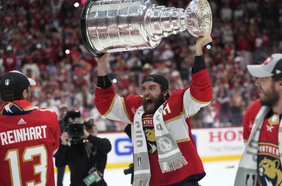 Florida Panthers defenseman Aaron Ekblad raises the NHL hockey Stanley Cup trophy after defeating the Edmonton Oilers in Game 7 of the Final, Monday, June 24, 2024, in Sunrise, Fla. (AP Photo/Wilfredo Lee)