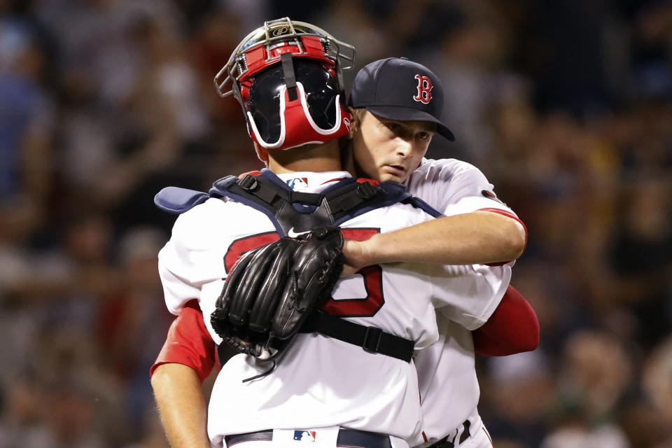Boston Red Sox closer Garrett Whitlock, right, is congratulated by catcher Kevin Plawecki, left, after Whitlock recorded the final out against New York Yankees' Josh Donaldson in the ninth inning of a baseball game at Fenway Park, Sunday Aug. 14, 2022, in Boston. Boston won 3-0. (AP Photo/Paul Connors)