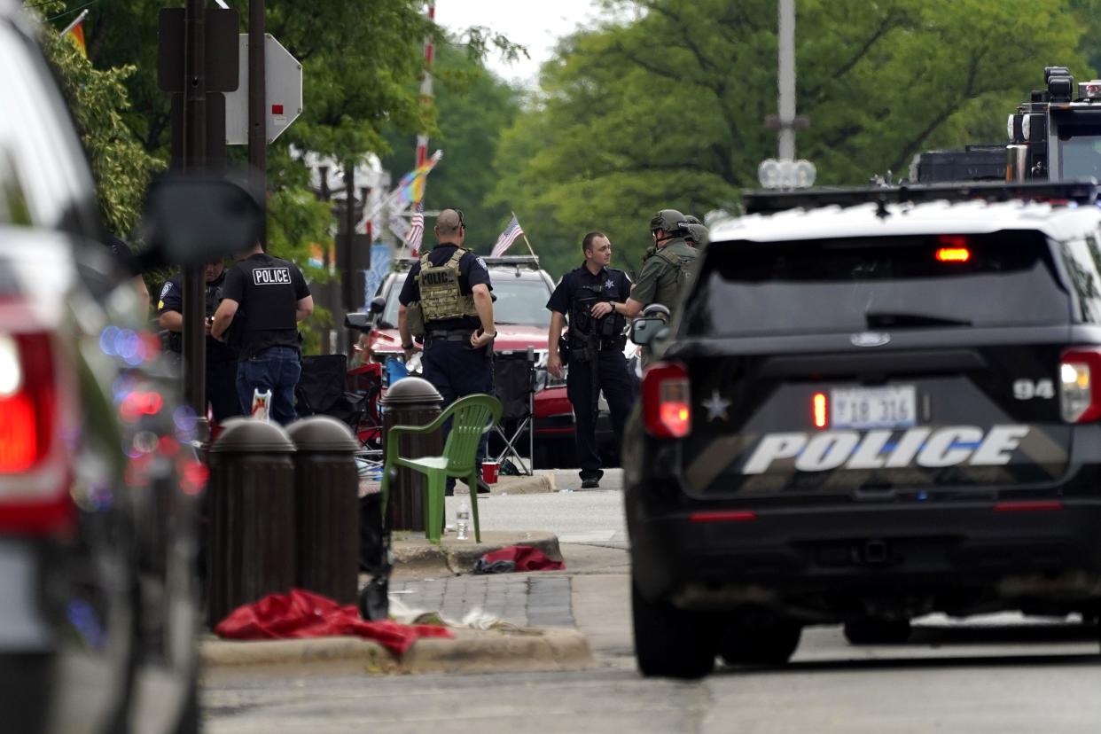 Law enforcement search in downtown Highland Park, a Chicago suburb, after a mass shooting at the Highland Park Fourth of July parade, Monday, July 4, 2022.