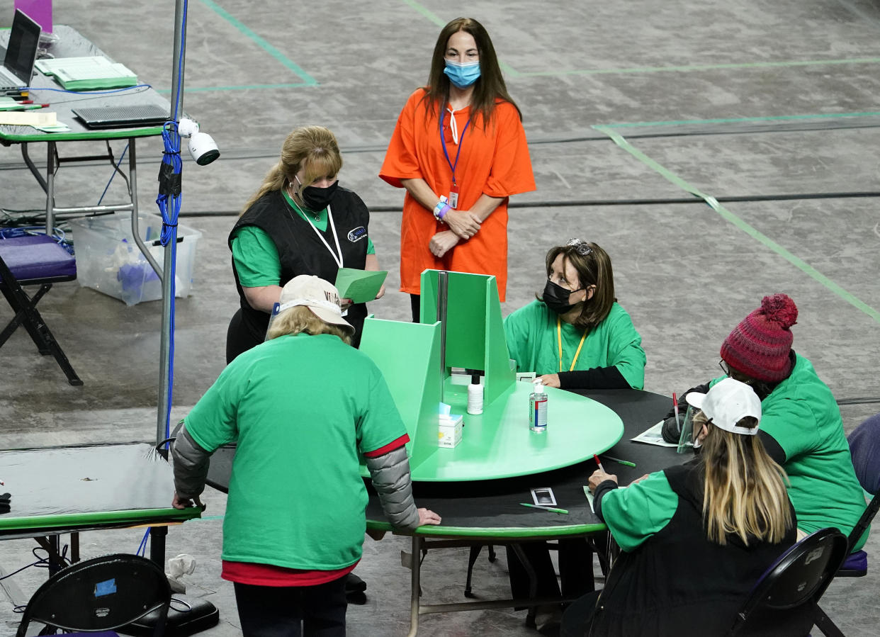 Maricopa County ballots cast in the 2020 general election are being examined and recounted by contractors working for Florida-based company, Cyber Ninjas, who was hired by the Arizona State Senate at Veterans Memorial Coliseum in Phoenix, Thursday, April 29, 2021. (Rob Schumacher/The Arizona Republic via AP, Pool)