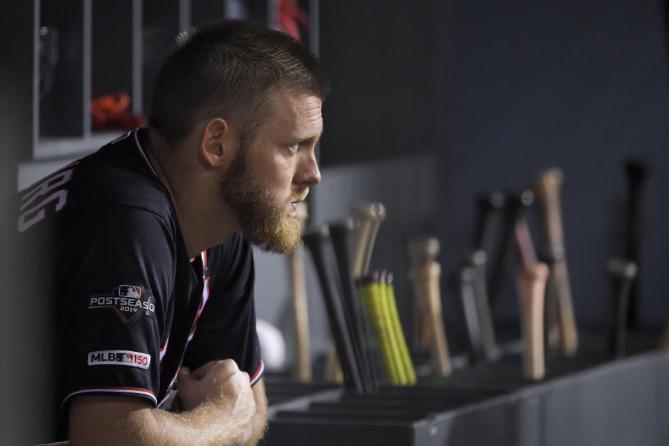 Washington Nationals starting pitcher Stephen Strasburg watches from the dugout during the seventh inning in Game 2 of the baseball team's National League Division Series against the Los Angeles Dodgers on Friday, Oct. 4, 2019, in Los Angeles. (AP Photo/Mark J. Terrill)