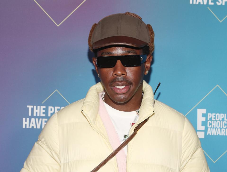 Photo of Tyler, The Creator at a premiere wearing a baseball cap and sunglasses