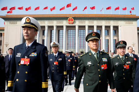 Military delegates leave the Great Hall of the People after a meeting ahead of National People's Congress (NPC), China's annual session of parliament, in Beijing, China March 4, 2019. REUTERS/Aly Song