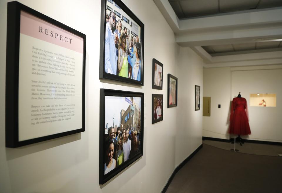 In a photo from Friday, Sept. 21, 2018, in Detroit, an exhibit at the Charles H. Wright Museum of African American History features a "tribute to the Queen of Soul." "THINK" opens to the public Tuesday at the museum that hosted Aretha Franklin's public visitations after her death last month. It features archival photographs, videos and the red shoes she wore at her first visitation that drew global attention. (AP Photo/Carlos Osorio)
