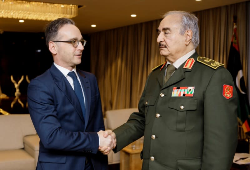 German Foreign Minister Maas shakes hands with Libya's commander Khalifa Haftar in Benghazi