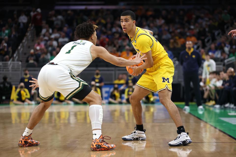 Michigan forward Caleb Houstan handles the ball against Colorado State forward John Tonje during the first half of the first round of the NCAA tournament in Indianapolis on Thursday, March 17, 2022.