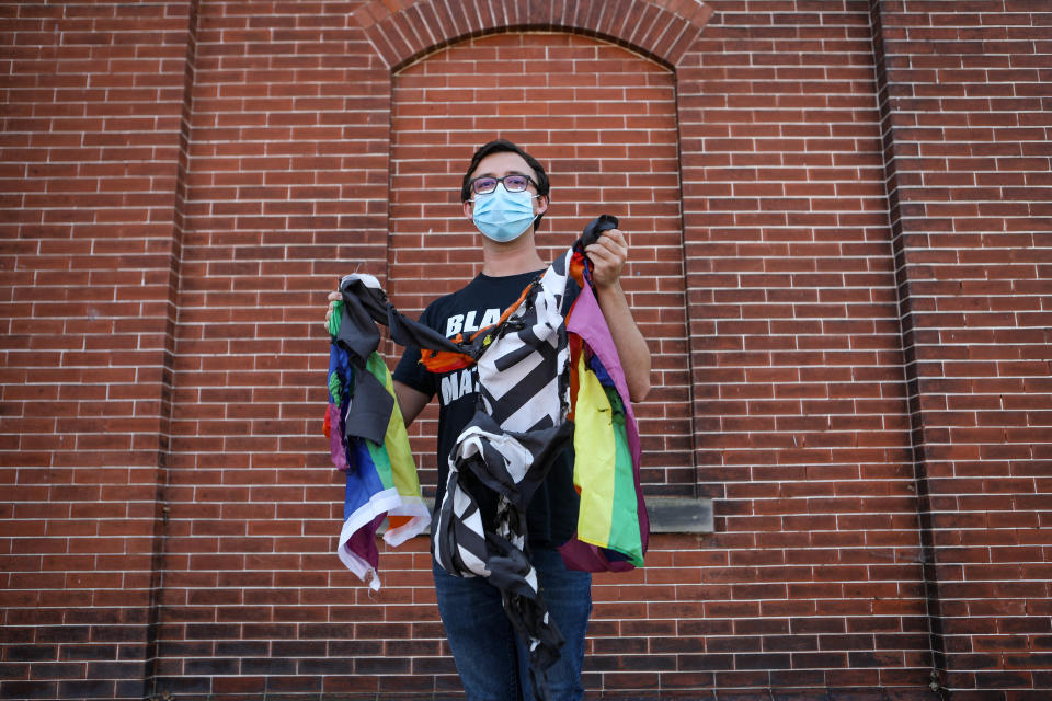 Pastoral resident Brent O'Neill holds burnt Black Lives Matter and LGBTQ+ flags in front of the Church on Main in Middletown on Sept. 8, 2020. The flags were stolen from the church, burnt and hung from a pole over the night of Aug. 12.