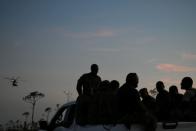 Members of the Bahamian military ride in the back of a truck in the wake of Hurricane Dorian in Marsh Harbour