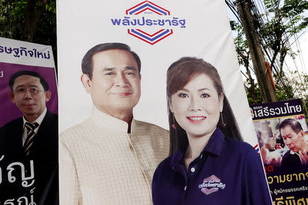 A picture of Thailand's Prime Minister Prayuth Chan-ocha is seen next to a candidate of Palang Pracharat party on an election campaign poster in Bangkok, Thailand, March 9, 2019. REUTERS/Athit Perawongmetha