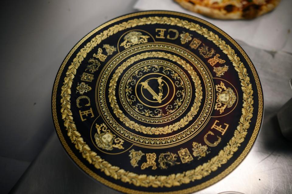 The pizza comes served on authentic Versace plateware. Stefano Giovannini for N.Y.Post
