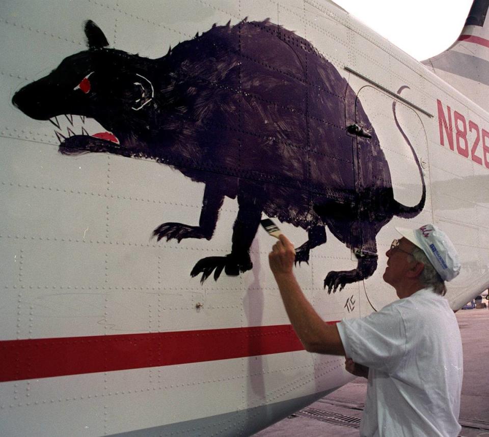 Thomas Cooper CEO/President of Gulfstream Airlines paints a rat on one of the companies planes, in support of the Florida Panthers in 1996.