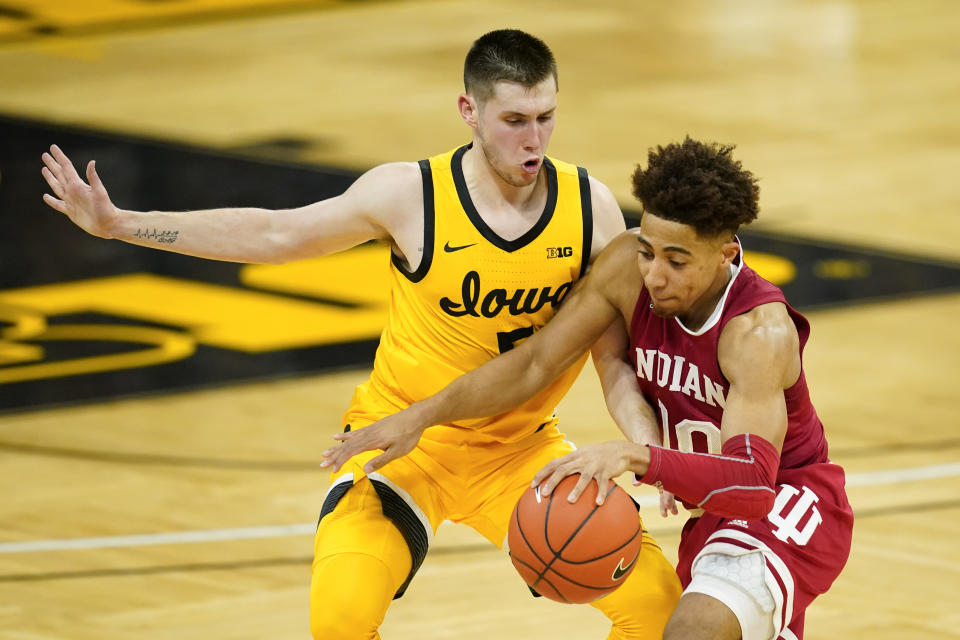 Iowa guard CJ Fredrick, left, tries to steal the ball from Indiana guard Rob Phinisee during the first half of an NCAA college basketball game, Thursday, Jan. 21, 2021, in Iowa City, Iowa. (AP Photo/Charlie Neibergall)