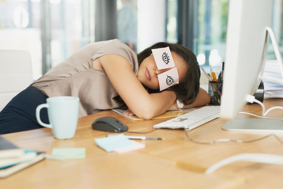 Woman taking a nap at her desk. (Getty Images)