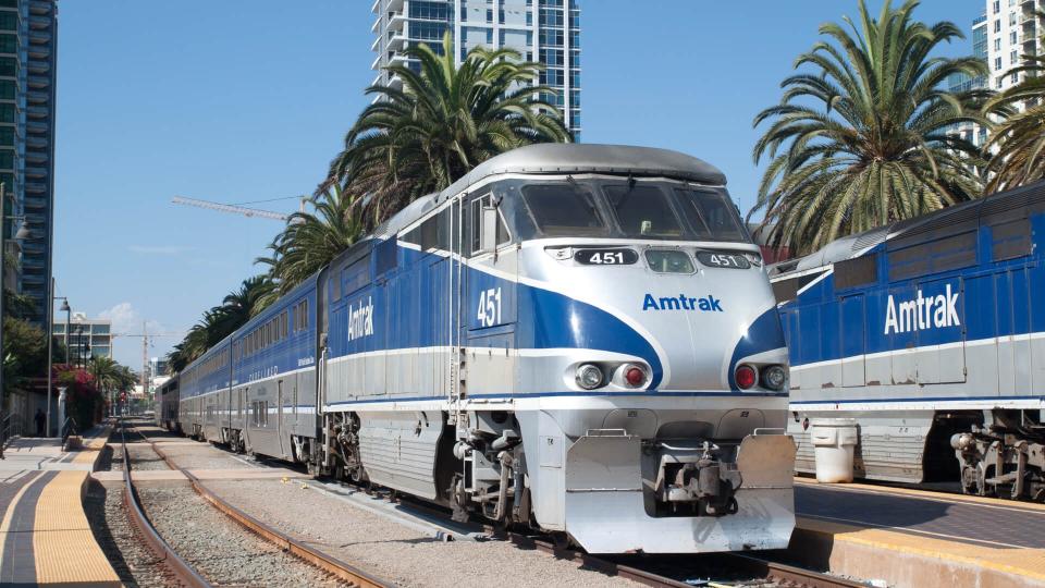 Amtrak California passenger train leaves the Santa Fe Depot station. The classic design station.