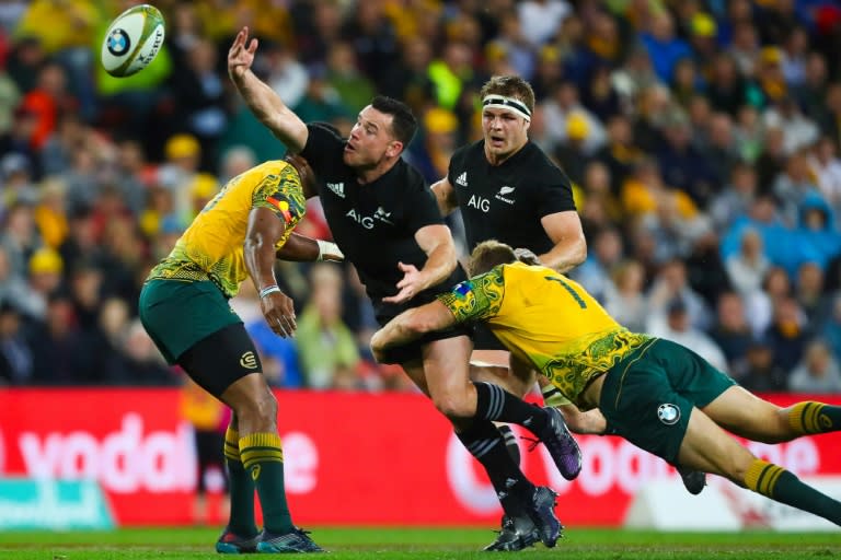 Ryan Crotty of New Zealand's All Blacks (2nd L) loses the ball as Michael Hooper of Australia's Wallabies tackles during their match in Brisbane on October 21, 2017