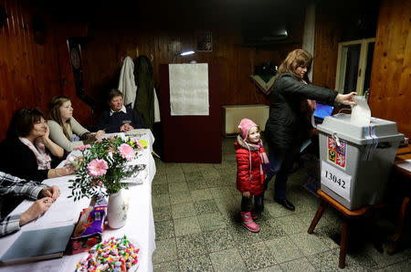 A woman casts her vote during the country's direct presidential election, at a polling station located in a pub in Prague, the Czech Republic January 12, 2018. REUTERS/David W Cerny