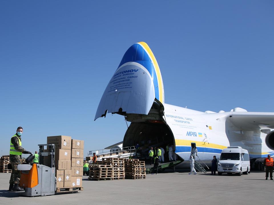 A Bundeswehr soldier unloads from an Antonov An-225 Mriya cargo aeroplane boxes with protective masks delivered from China on April 27, 2020 at the airport of Leipzig in eastern Germany.