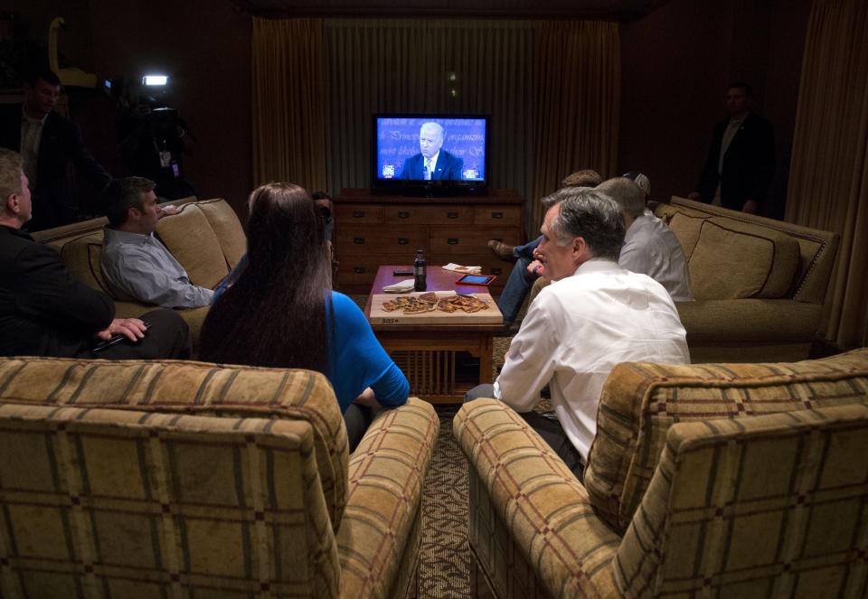 Republican presidential candidate, former Massachusetts Gov. Mitt Romney, right, watches the vice presidential debate in his hotel room on Thursday, Oct. 11, 2012 in Asheville, N.C. (AP Photo/ Evan Vucci)