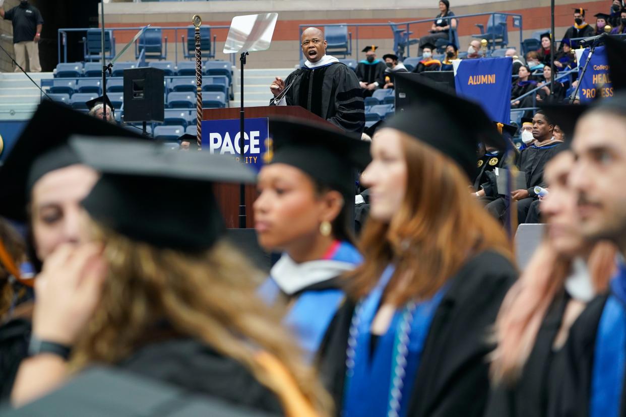 New York City Mayor Eric Adams speaks as some graduates turn their back to him in protest during a graduation ceremony for Pace University at the USTA Billie Jean King Tennis Center in Flushing, Queens, New York on Monday, May 16, 2022.