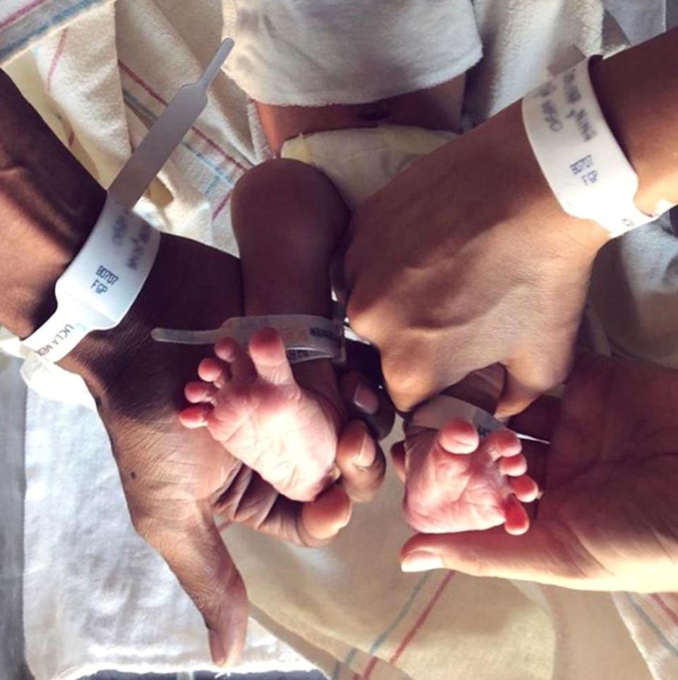 Nora's feet with her parents' hands | Jay Ellis Instagram