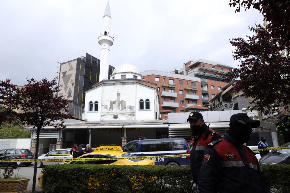 Albanian police stand outside Dine Hoxha mosque, after a knife attack in Tirana, Albania, Monday, April 19, 2021. Police say an Albanian man with a knife has attacked five people at a mosque in the capital of Tirana. A police statement said Rudolf Nikolli, 34, entered the Dine Hoxha mosque in downtown Tirana about 2:30 p.m. and wounded five people with a knife. (AP Photo)