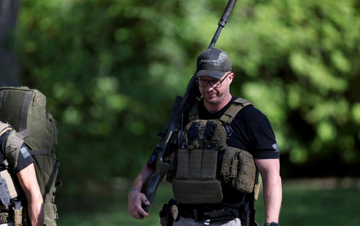 An officer at the scene of the shooting in Charlotte. The suspect opened fire on officers with a "high-powered rifle"