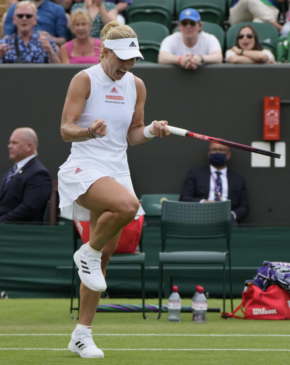 Germany's Angelique Kerber celebrates during the women's singles second round match against Spain's Sara Sorribes Tormo on day four of the Wimbledon Tennis Championships in London, Thursday July 1, 2021. (AP Photo/Alastair Grant)