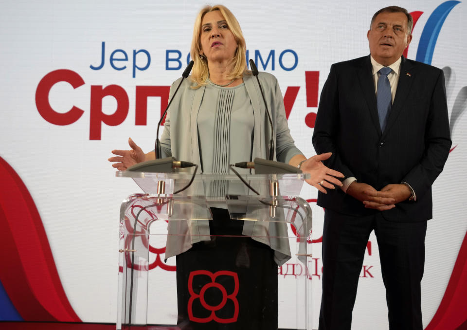 Bosnian Serb leader Milorad Dodik, right, listens as Zeljka Cvijanovic, planned successor for the post of Serbian member of the presidency, speaks during a news conference after claiming victory in a general election in the Bosnian town of Banja Luka, 240 kms northwest of Sarajevo, Monday, Oct. 3, 2022. (AP Photo/Darko Vojinovic)