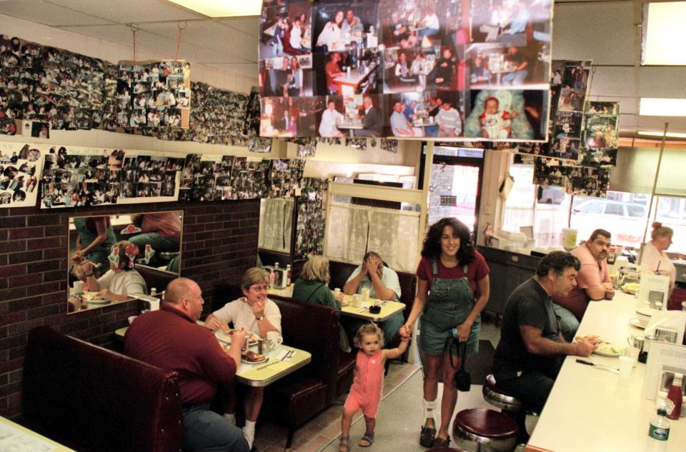 Photographs of customers adorned the wall of Charlie's Good Egg, a breakfast spot at 12 Broadway in Newport.