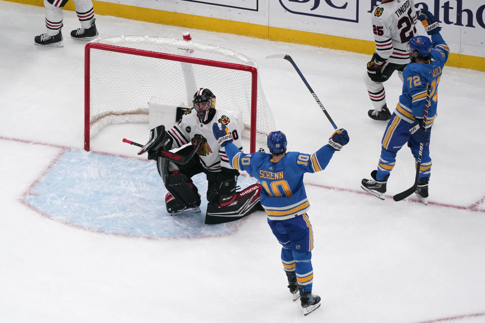 St. Louis Blues' Justin Faulk (72) celebrates after scoring past Chicago Blackhawks goaltender Arvid Soderblom, left, as teammate Brayden Schenn (10) watches during the third period of an NHL hockey game Saturday, Dec. 23, 2023, in St. Louis. (AP Photo/Jeff Roberson)