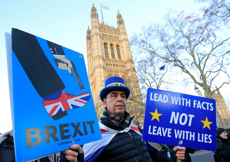 Westminster protester and anti Brexit activist Steve Bray holds his placards after a Reuters interview near the Parliament Buildings in Westminster