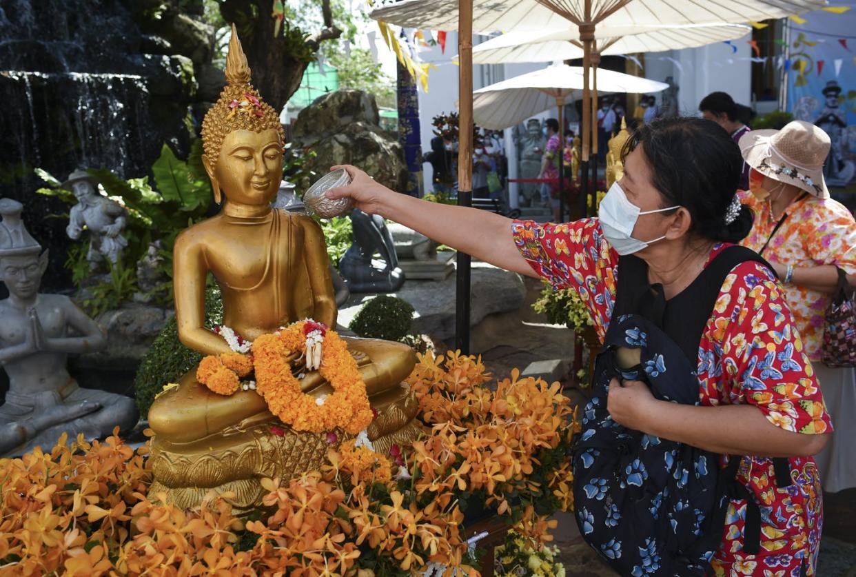 <span class="caption">International tourism dropped considerably to Thailand Buddhist temples as a result of the COVID-19 pandemic.</span> <span class="attribution"><a class="link " href="https://www.gettyimages.com/detail/news-photo/woman-scented-water-on-a-buddha-statue-as-they-celebrate-news-photo/1232284817?adppopup=true" rel="nofollow noopener" target="_blank" data-ylk="slk:Anusak Laowilas/NurPhoto via Getty Images;elm:context_link;itc:0;sec:content-canvas">Anusak Laowilas/NurPhoto via Getty Images</a></span>