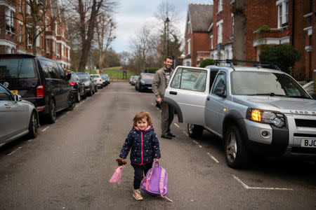 Adi, 37, who works for a removal company takes his daughter, Elena, who is two years and seven-months old, to nursery in London, Britain, February 7, 2019. REUTERS/Alecsandra Dragoi