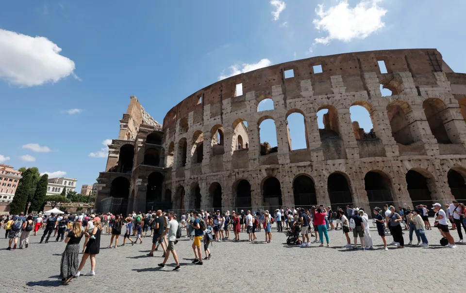 Tourists wait in line to enter the Colosseum in Rome, Italy.