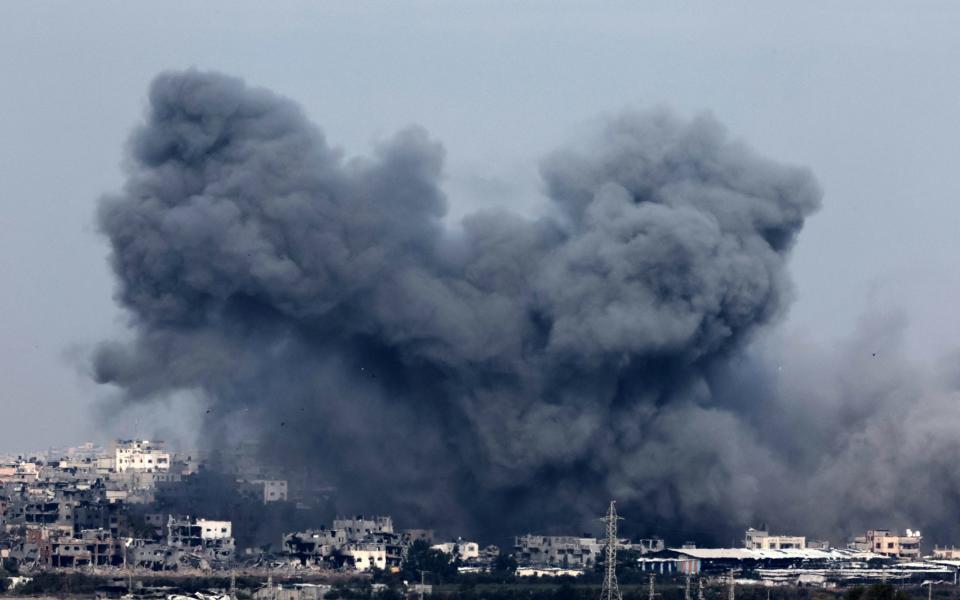 Smoke rises above building during an Israeli strike in northern Gaza