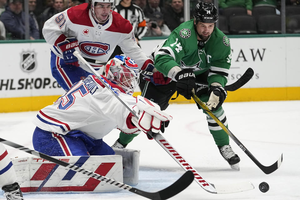 Montreal Canadiens goaltender Sam Montembeault (35) and center Sean Monahan (91) defend the goal against Dallas Stars left wing Jamie Benn (14) during the first period an NHL hockey game in Dallas, Tuesday, Jan. 2, 2024. (AP Photo/LM Otero)