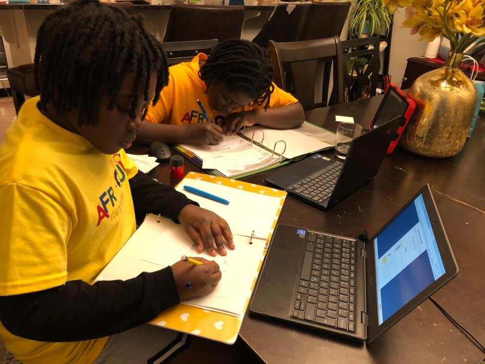 Samson Vanderpuye, left, and his older brother Isaiah Vanderpuye are seen at home in Edmonton studying for the 2024 edition of AfroQuiz, the long-running annual Jeopardy!-style competition hosted by the Council of Canadians of African and Caribbean Heritage.