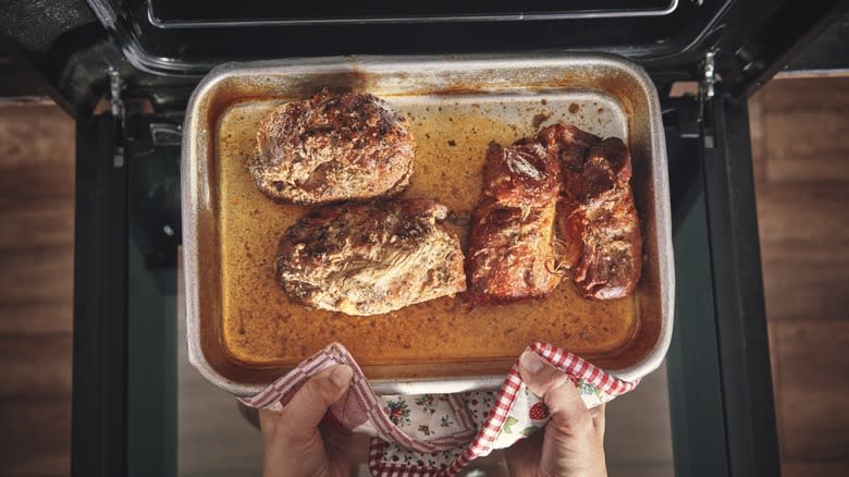 removing pulled pork from the oven