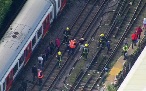 Passengers file off a train near Parsons Green - Credit: Pool