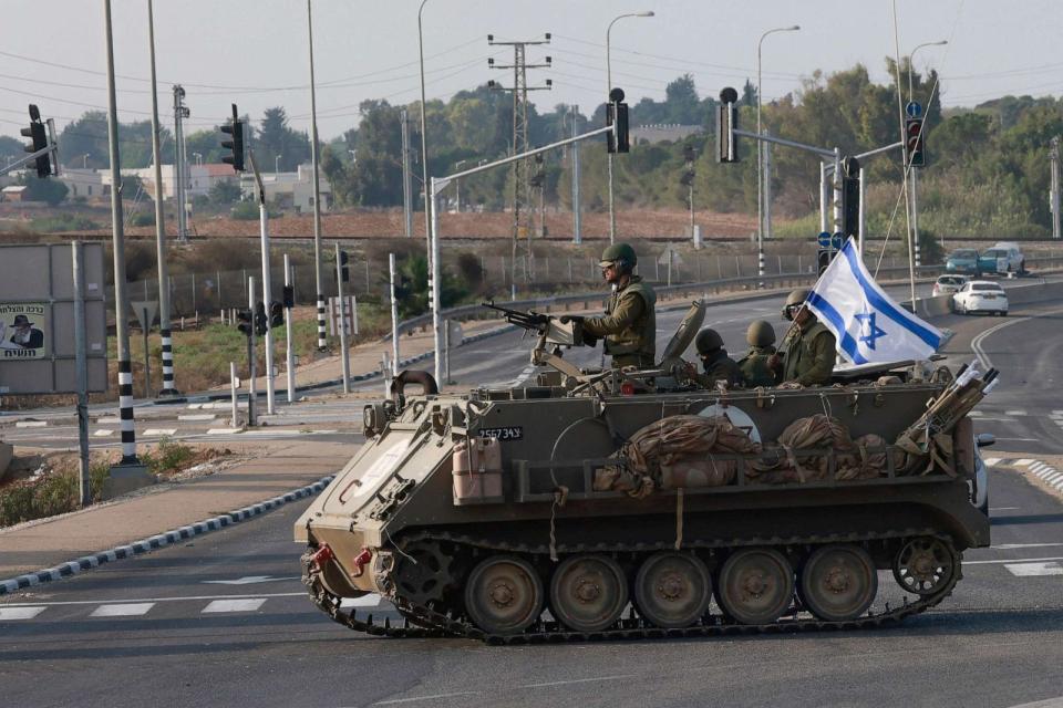 PHOTO: Israeli forces cross a main road in their armoured personnel carrier (APC) as additional troops are deployed near the southern city of Sderot on Oct. 8, 2023. (Menahem Kahana/AFP via Getty Images)