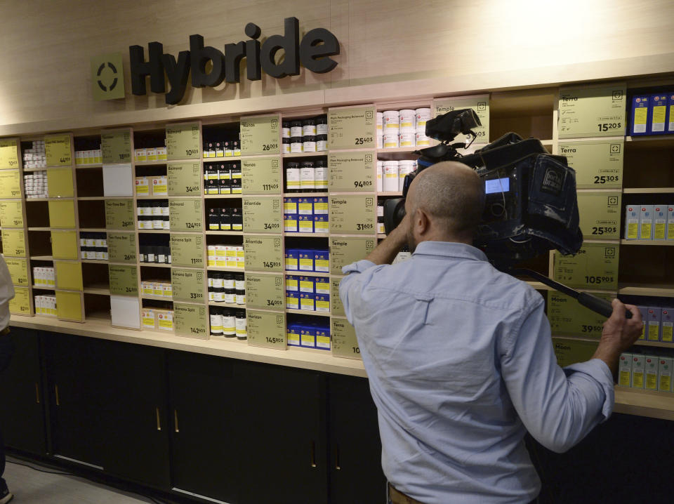 Members of the media attend a preview for one of Quebec's new cannabis stores in Montreal, Tuesday, Oct.1 6, 2018. Canada will become the second and largest country with a legal national marijuana marketplace when sales begin on midnight Wednesday. (Ryan Remiorz/The Canadian Press via AP)