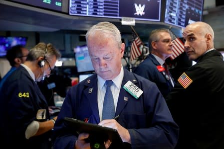 Traders work on the floor at the NYSE in New York