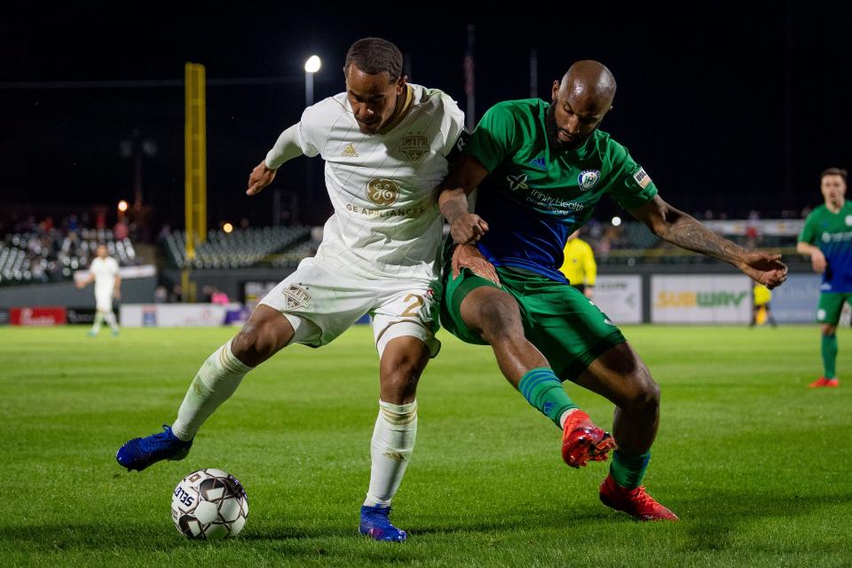 Louisville City FC midfielder George Davis IV (22) plays against Raymond Lee (3) during the season opening match in Louisville, Ky., Saturday, March 23, 2019. 