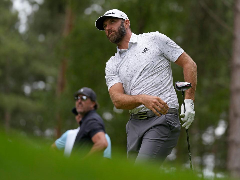 Dustin Johnson watches his shot during the first round of the LIV Golf Invitational in London.