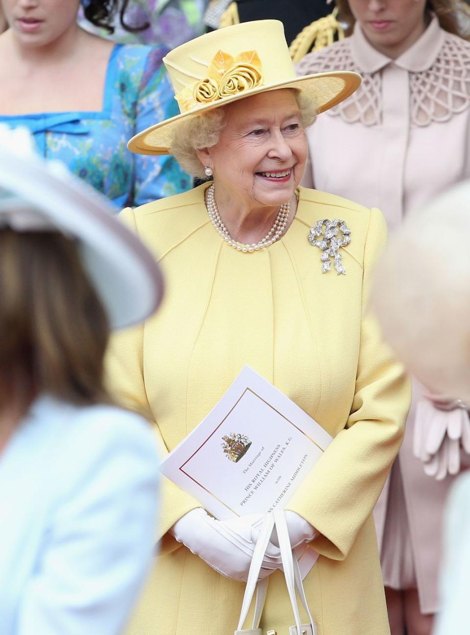 <p>Queen Elizabeth chose a lemon yellow dress and matching hat for Prince William and Kate Middleton's wedding at Westminster Abbey.</p>