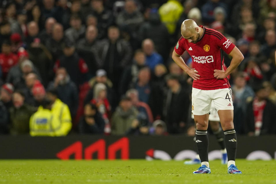 Manchester United's Sofyan Amrabat reacts after Newcastle's Joe Willock scoring his side's third goal during the EFL Cup fourth round soccer match between Manchester United and Newcastle at Old Trafford stadium in Manchester, England, Wednesday, Nov. 1, 2023. (AP Photo/Dave Thompson)