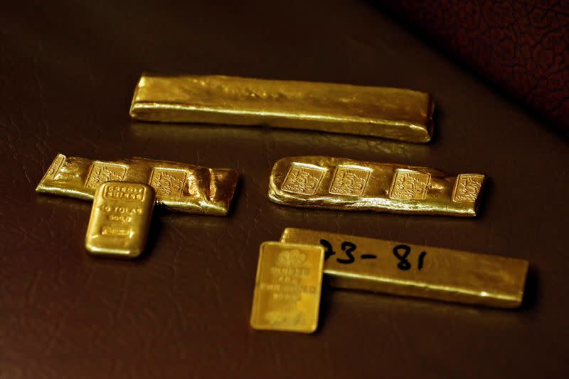 Gold ingots inscribed with details are displayed at a wholesale gold shop, in Peshawar