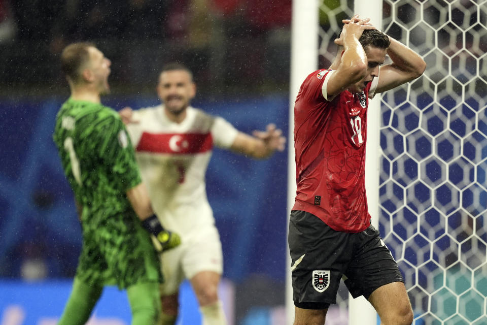 Austria's Christoph Baumgartner, right, reacts following a save by Turkey's goalkeeper Mert Gunok, left, during a round of sixteen match at the Euro 2024 soccer tournament in Leipzig, Germany, Tuesday, July 2, 2024. . (Fabio Ferrari/LaPresse via AP)