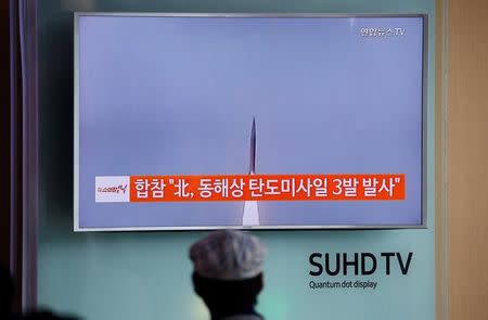 A passenger watches a TV screen broadcasting a news report on North Korea firing three ballistic missiles into the sea off its east coast, at a railway station in Seoul, South Korea, September 5, 2016. REUTERS/Kim Hong-Ji