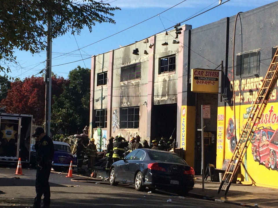 Oakland, California, firefighters inspect a warehouse on December 3, 2016, where a fire during a rave party killed 9 people on December 2. Nine people were killed and 25 missing after a huge blaze broke out during a rave party near San Francisco held in a cluttered, maze-like warehouse for artists, known as 'Oakland Ghostship,' fire officials said Saturday. / AFP / Virginie GOUBIER        (Photo credit should read VIRGINIE GOUBIER/AFP/Getty Images)